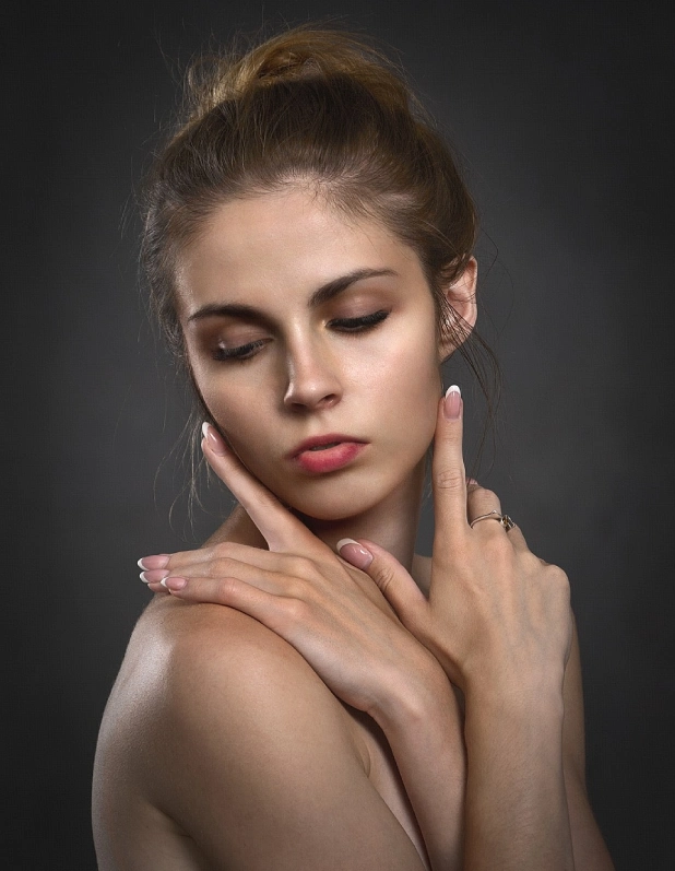 A woman with her hands on her chest.