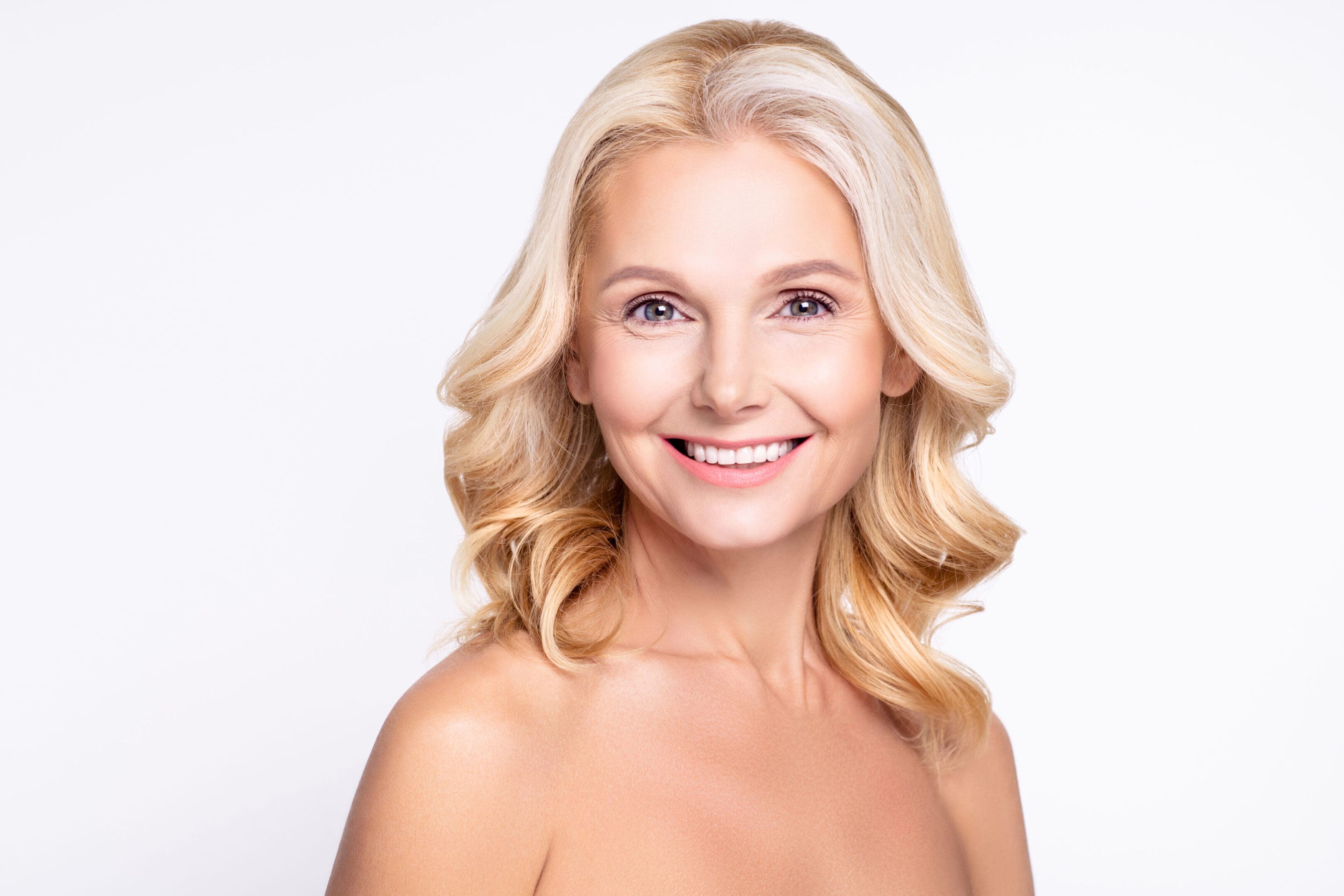 A woman with blonde hair and bare shoulders.